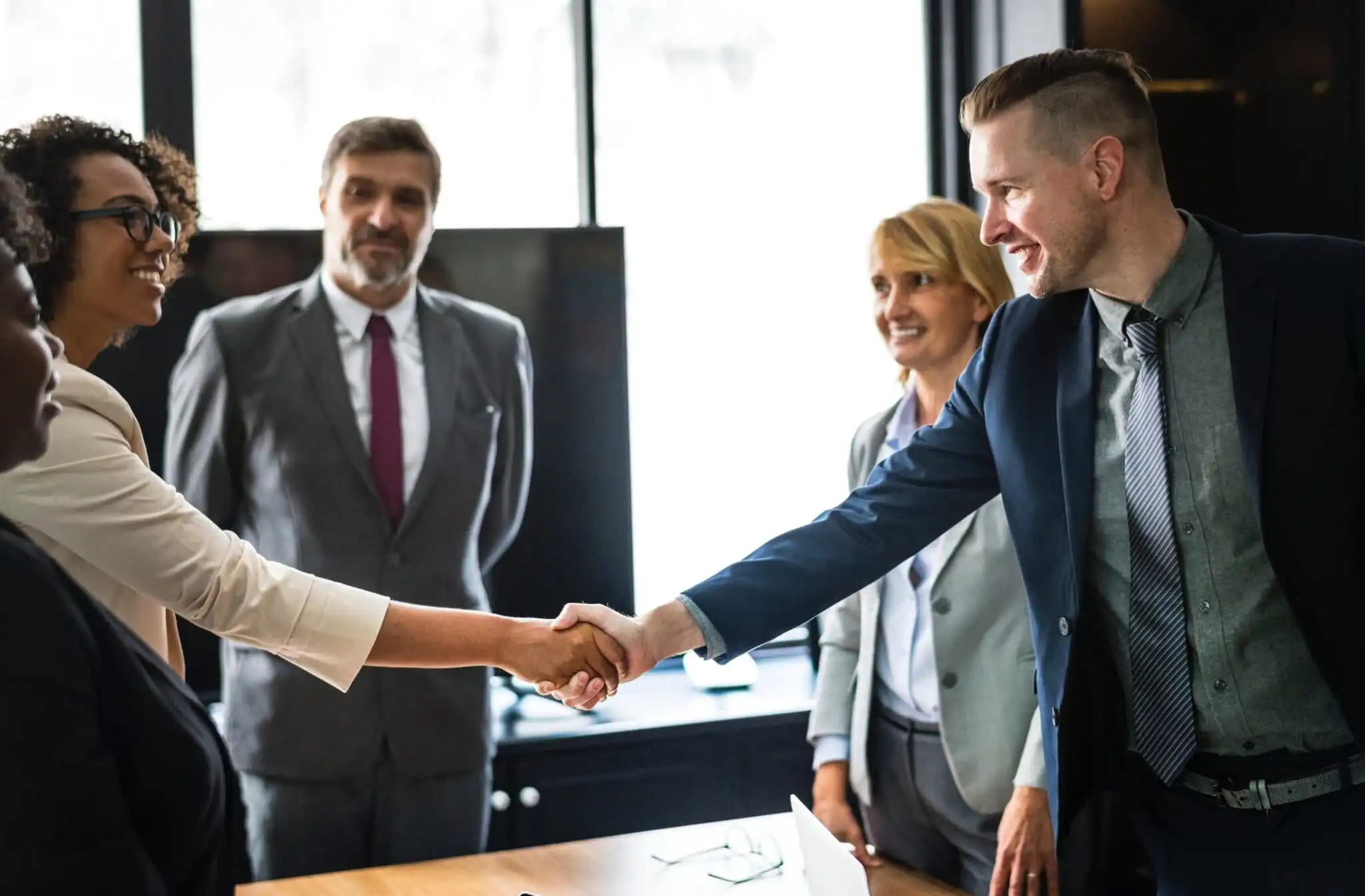 Group of business people shaking hands for the - Engineering Recruitment Agencies blog post